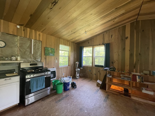 4750 Laws Rd, Del Rio, TN 37727 - kitchen featuring stainless steel gas stove, lofted ceiling, dark countertops, white cabinetry, and heating unit