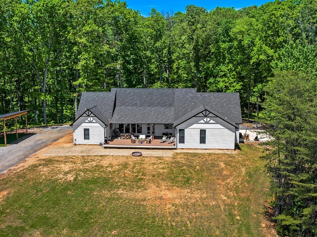 1670 Bays Mountain Rd, New Market, TN 37820 - ranch-style house with roof with shingles, a deck, a wooded view, a front lawn, and gravel driveway