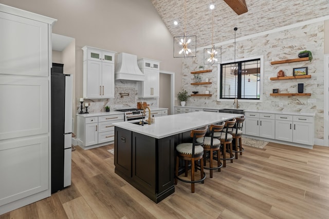 1670 Bays Mountain Rd, New Market, TN 37820 - kitchen with high vaulted ceiling, open shelves, freestanding refrigerator, light countertops, and custom range hood