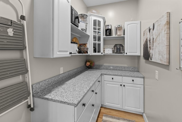 1670 Bays Mountain Rd, New Market, TN 37820 - kitchen with open shelves, light wood-type flooring, white cabinets, and radiator heating unit