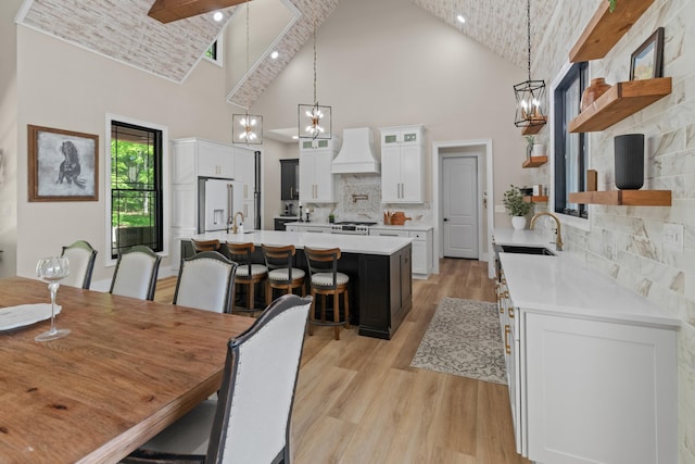 1670 Bays Mountain Rd, New Market, TN 37820 - dining space featuring light wood-type flooring, high vaulted ceiling, and a chandelier