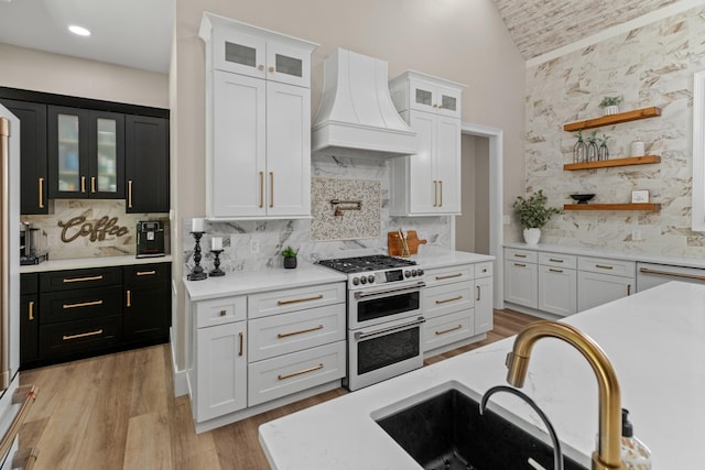 1670 Bays Mountain Rd, New Market, TN 37820 - kitchen featuring range with two ovens, dark cabinetry, a sink, custom range hood, and light countertops