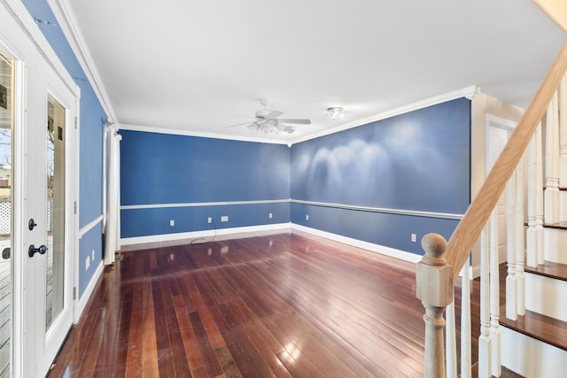 unfurnished room with wood-type flooring, ornamental molding, a ceiling fan, baseboards, and stairs