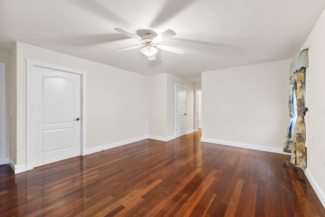 spare room featuring hardwood / wood-style floors, a ceiling fan, and baseboards