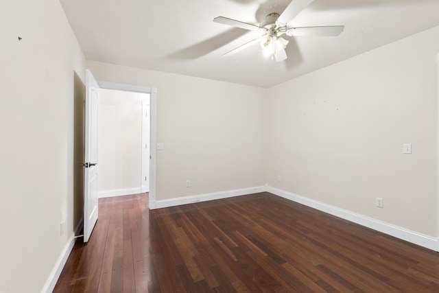 empty room with ceiling fan, baseboards, and dark wood-style flooring