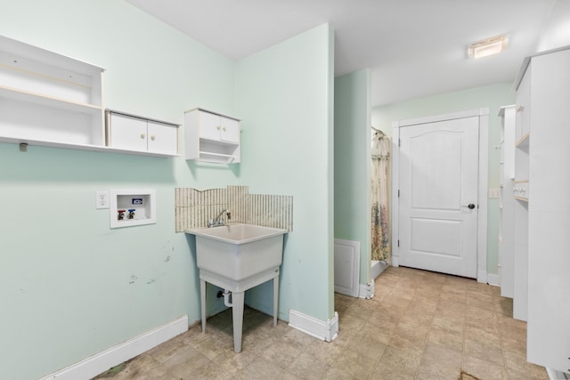 washroom featuring laundry area, baseboards, and washer hookup