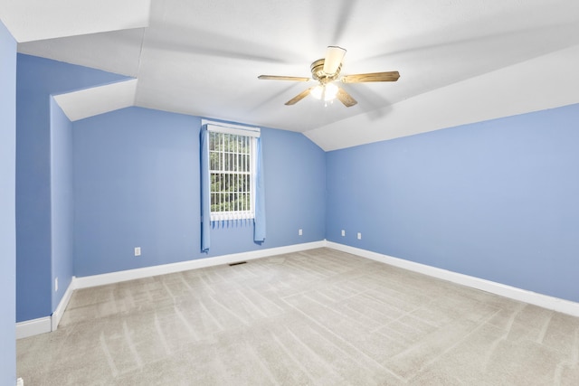 additional living space with vaulted ceiling, carpet floors, a ceiling fan, and baseboards