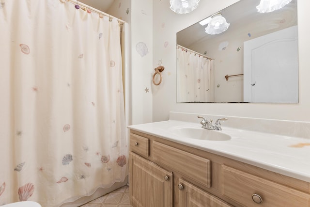 bathroom featuring curtained shower and vanity