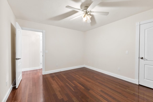 unfurnished room featuring dark wood-type flooring, baseboards, and a ceiling fan