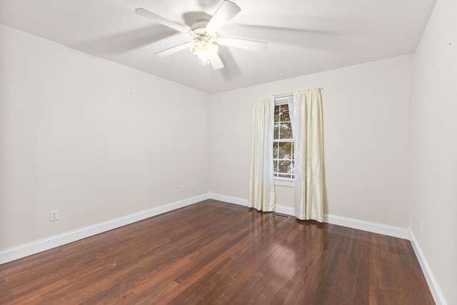 empty room featuring ceiling fan, baseboards, and hardwood / wood-style floors