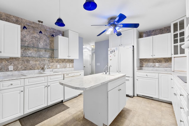 kitchen featuring white appliances, a sink, white cabinetry, and a ceiling fan