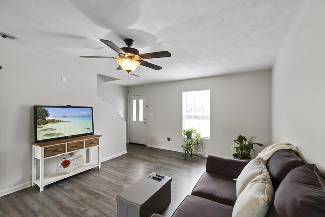 living room featuring dark hardwood / wood-style floors and ceiling fan