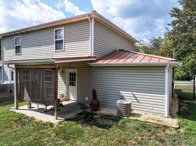 rear view of house with a yard