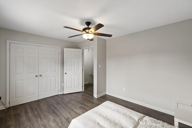 unfurnished bedroom featuring dark hardwood / wood-style flooring, a closet, and ceiling fan