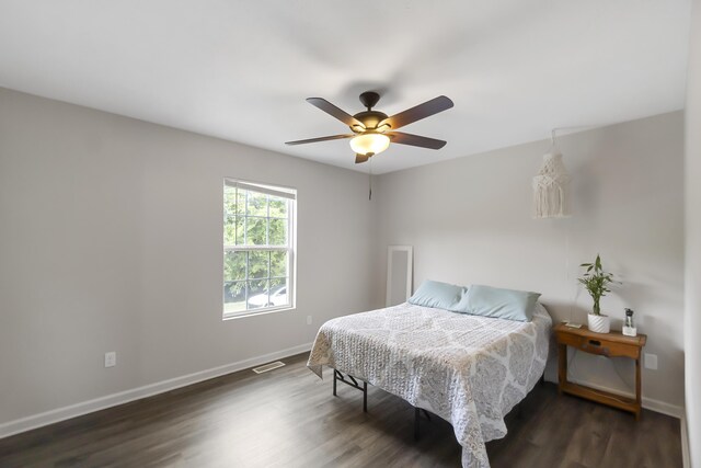 bedroom with ceiling fan and dark wood-type flooring