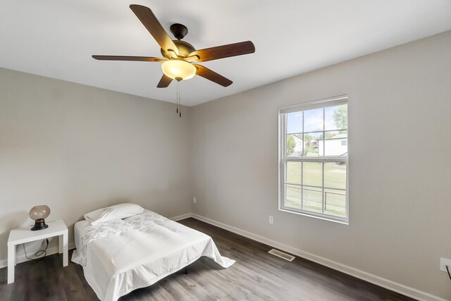 bedroom featuring dark hardwood / wood-style floors and ceiling fan