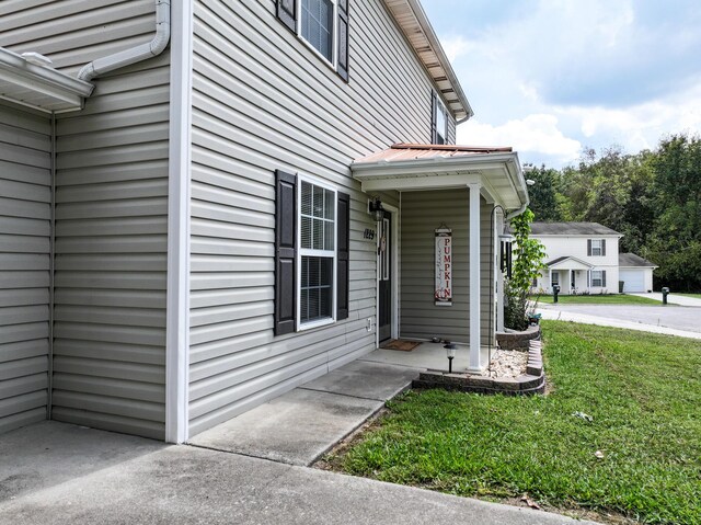 property entrance with a yard