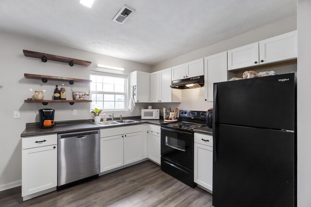 kitchen with white cabinetry, sink, black appliances, and dark hardwood / wood-style floors