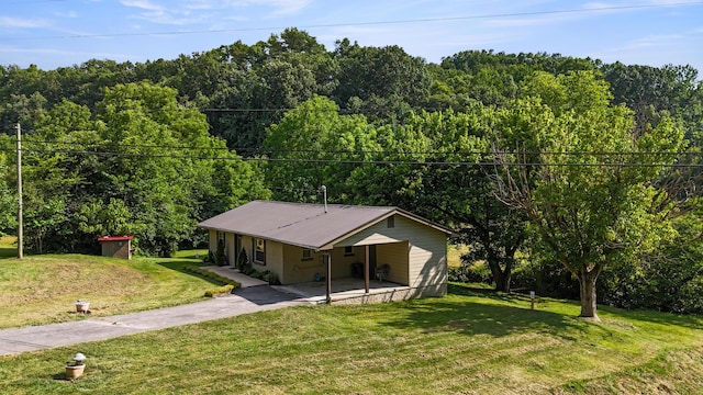 2368 Hall Rd, Dandridge, TN 37725 - view of front of house with a view of trees, concrete driveway, a front lawn, and a metal roof