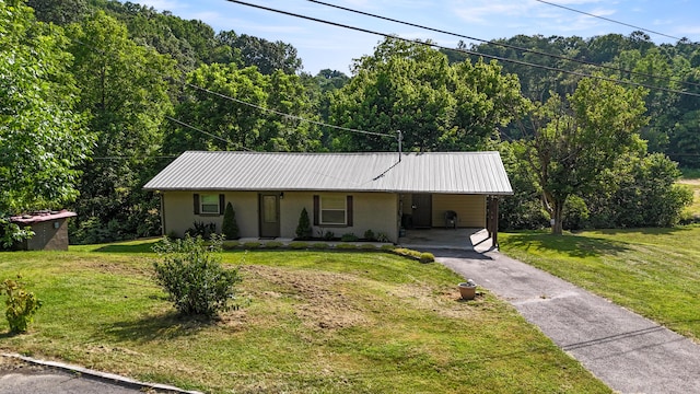 2368 Hall Rd, Dandridge, TN 37725 - single story home with driveway, a carport, stucco siding, a view of trees, and a front yard