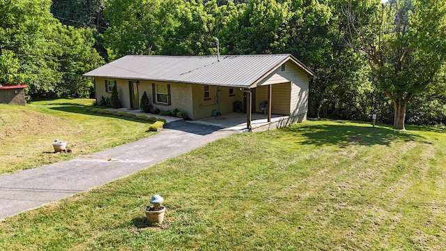 2368 Hall Rd, Dandridge, TN 37725 - view of front of home with asphalt driveway, an attached carport, a front lawn, a metal roof, and stucco siding