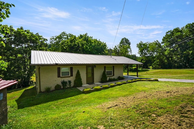 2368 Hall Rd, Dandridge, TN 37725 - view of front of home with stucco siding, a front lawn, a metal roof, and a carport