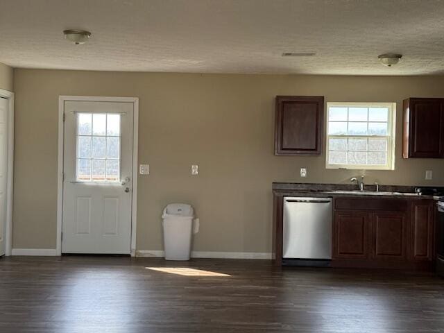 kitchen with a sink, stainless steel dishwasher, a healthy amount of sunlight, and dark wood-style flooring