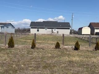 view of yard featuring a rural view and fence