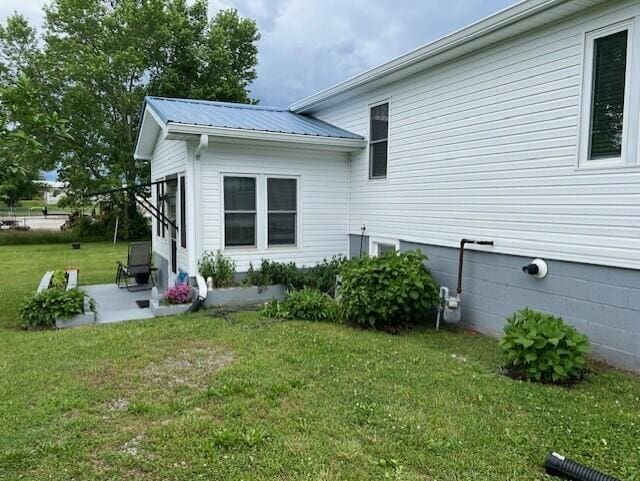 3207 Dove Ln, White Pine, TN 37890 - rear view of property featuring a lawn, a patio area, and metal roof