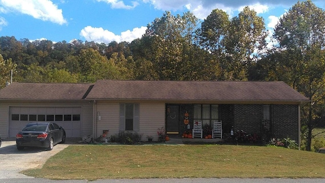 single story home featuring a porch, a garage, and a front yard