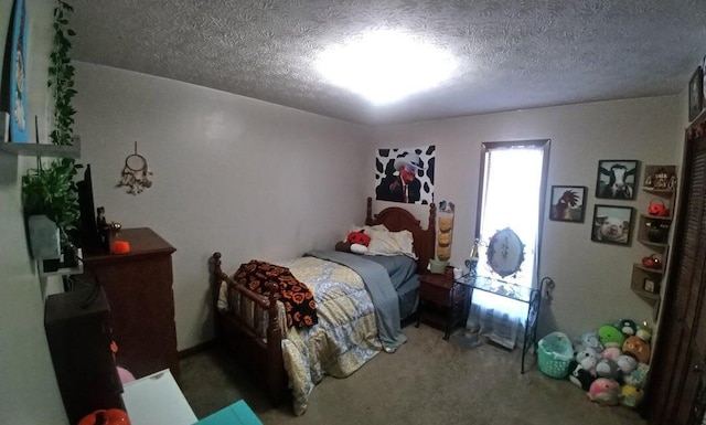 bedroom with carpet floors and a textured ceiling