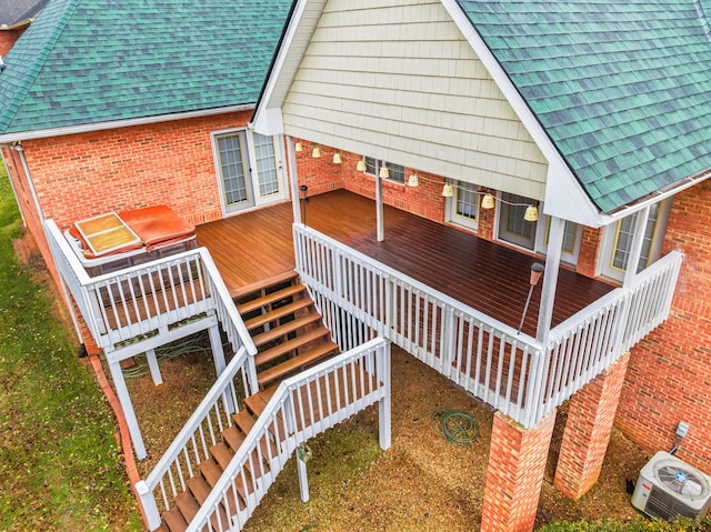 exterior space featuring a wooden deck and central AC