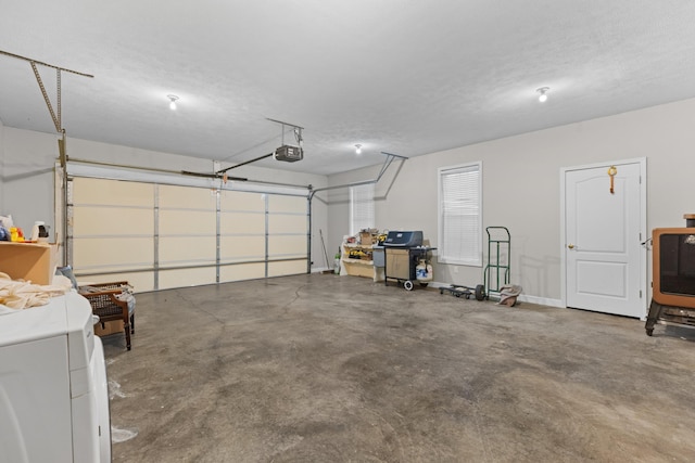 garage with a garage door opener and washer / dryer