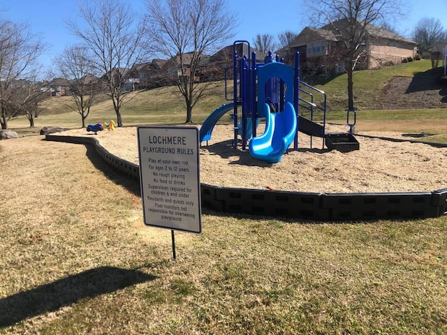 view of jungle gym featuring a lawn