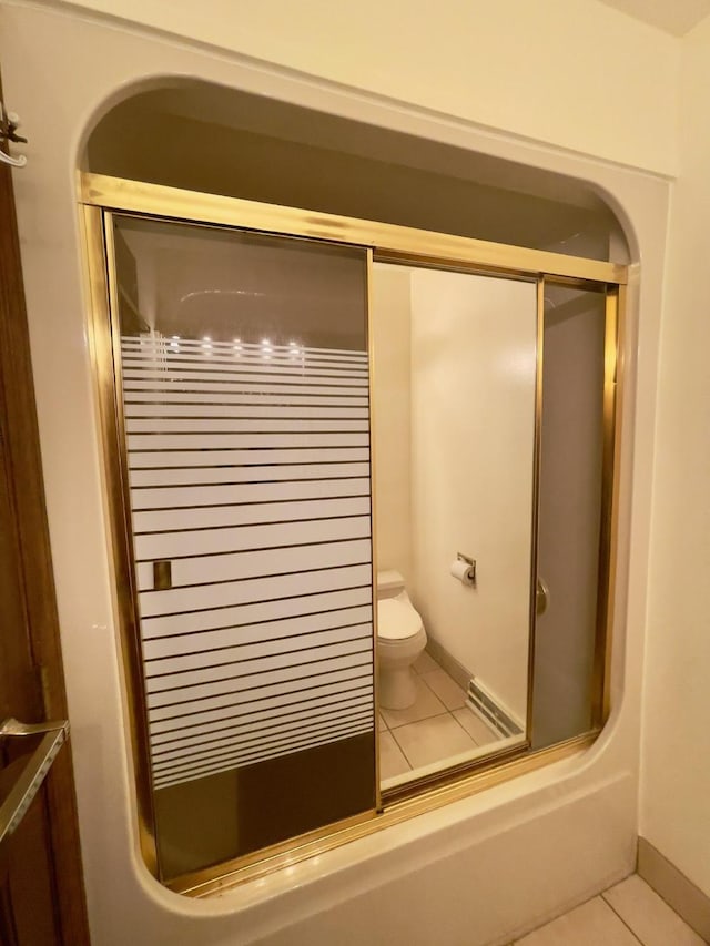 interior space with tile patterned floors, enclosed tub / shower combo, and toilet