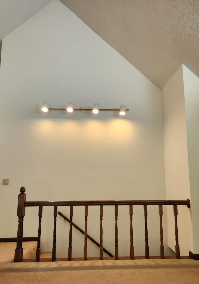 staircase with carpet flooring and lofted ceiling