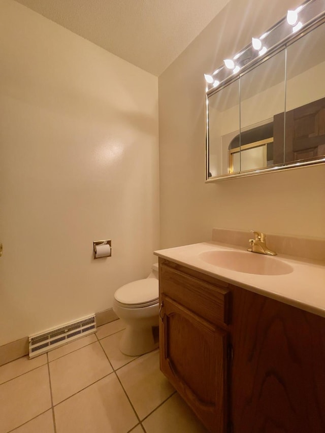 bathroom with tile patterned flooring, vanity, and toilet