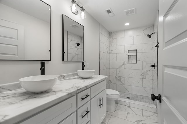 2490 Stream View Ln, Morristown, TN 37814 - bathroom featuring marble look tiles, double vanity, a tile shower, and recessed lighting
