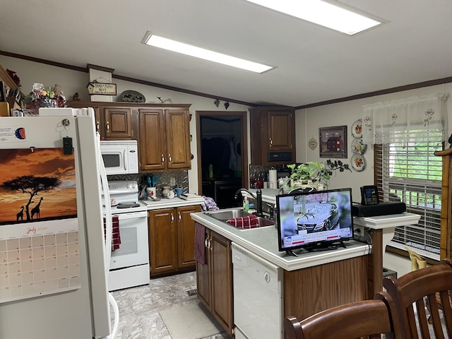 kitchen with white appliances, vaulted ceiling, crown molding, sink, and an island with sink