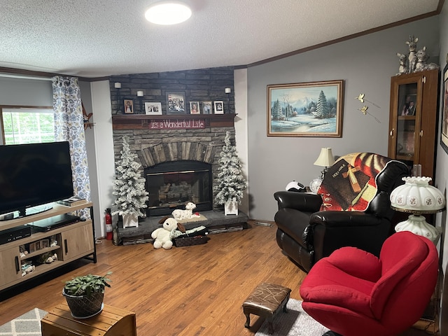 living room featuring a stone fireplace, lofted ceiling, wood-type flooring, and a textured ceiling