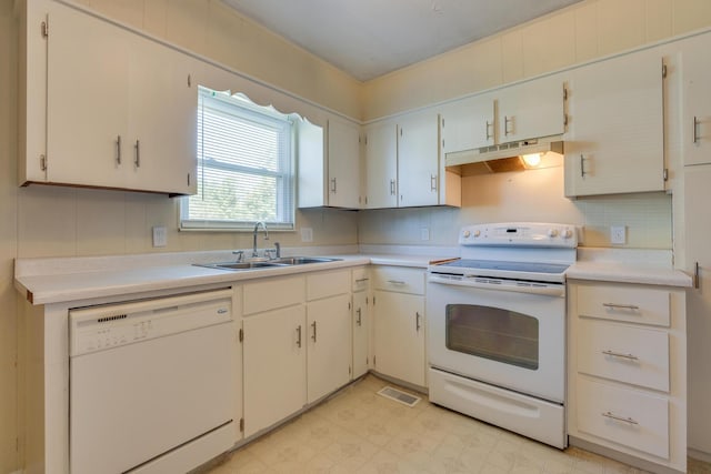 kitchen with white appliances, white cabinetry, and sink