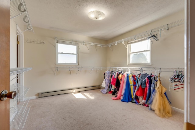 walk in closet with carpet and a baseboard radiator