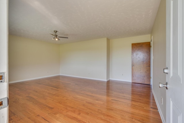 spare room featuring a textured ceiling, light hardwood / wood-style floors, and ceiling fan