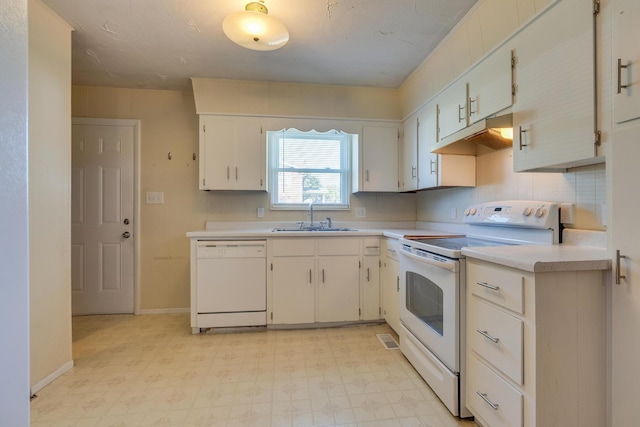 kitchen featuring sink, white cabinets, and white appliances