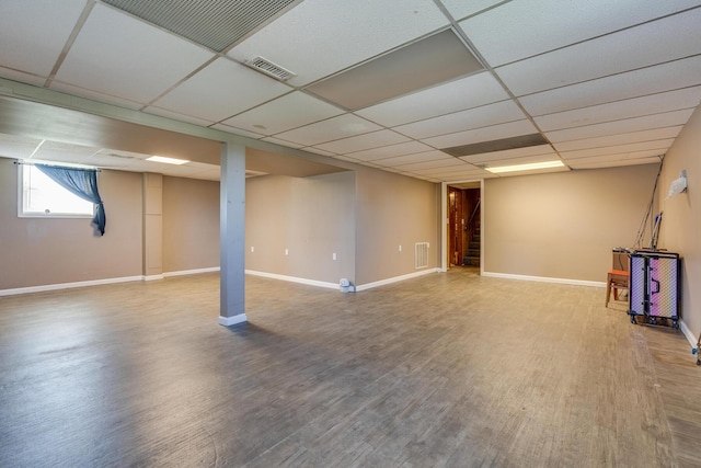 basement with wood-type flooring and a drop ceiling