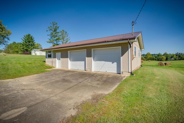 garage featuring a lawn