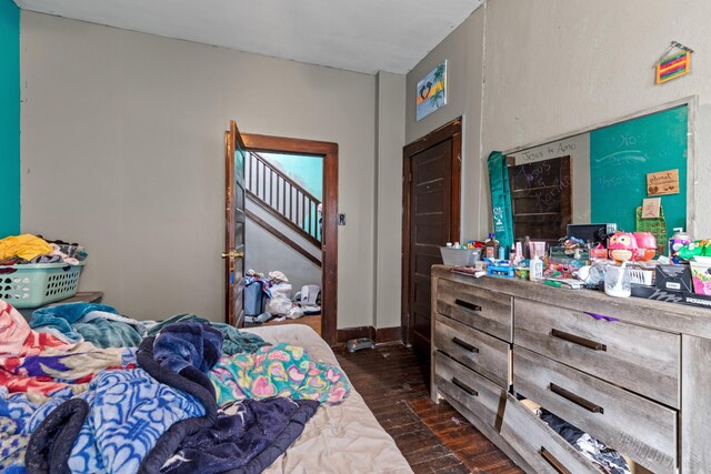 bedroom with dark wood finished floors