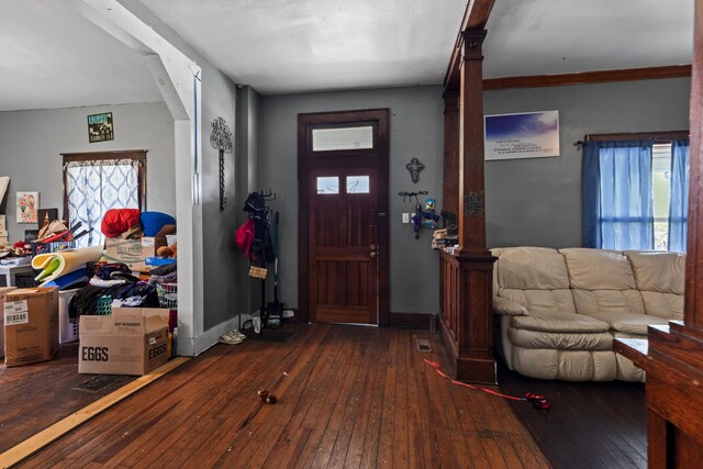 foyer with baseboards and wood-type flooring