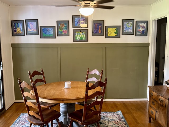 302 Buckingham Dr, Newport, TN 37821 - dining space featuring a ceiling fan, wood finished floors, crown molding, a decorative wall, and a wainscoted wall