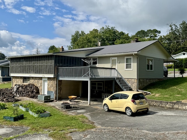 302 Buckingham Dr, Newport, TN 37821 - view of front facade featuring stone siding, a front yard, a deck, and a metal roof